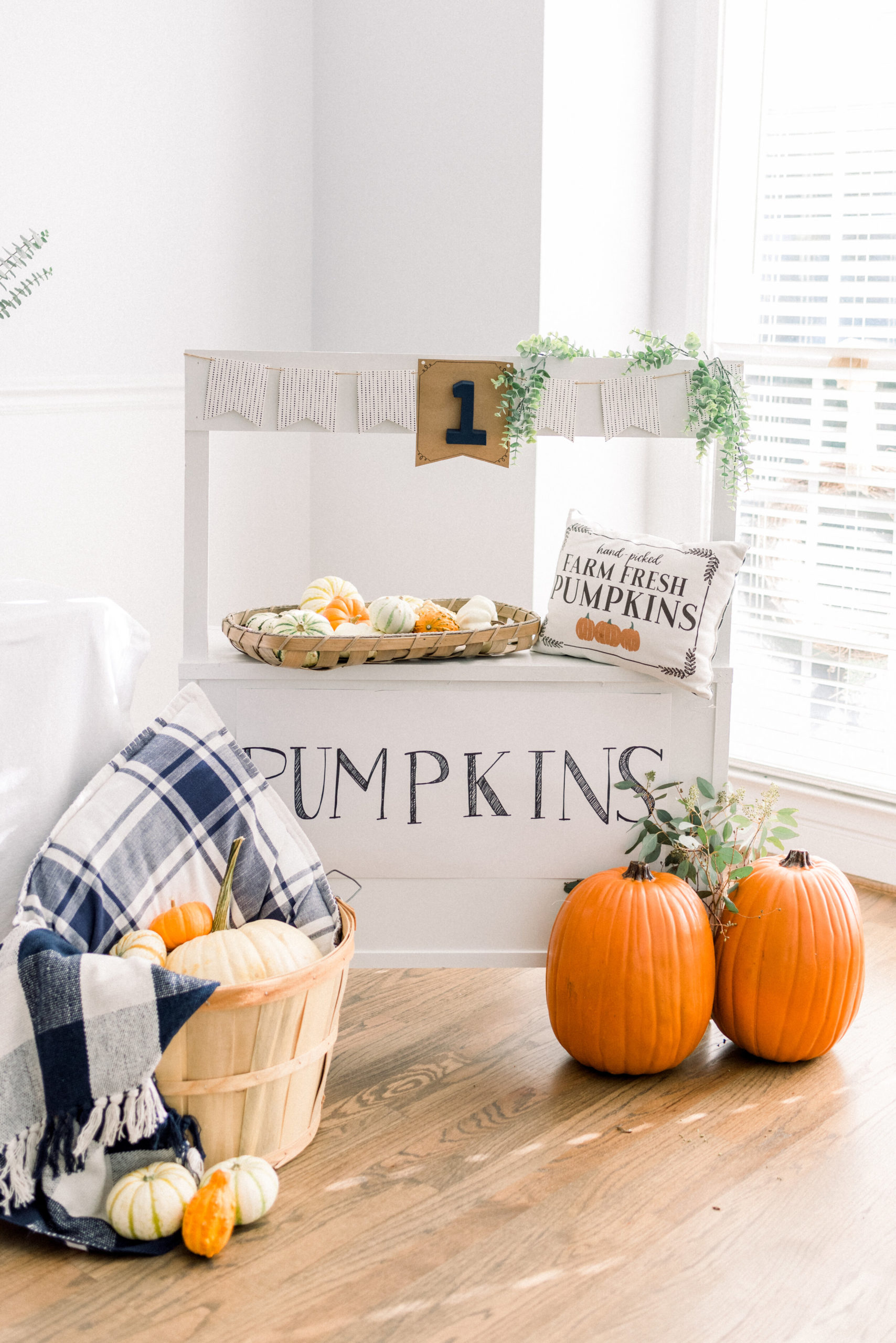Blue &amp; white check throw -  Amazon   Pumpkins - Walmart  Pillow - TJ Maxx/Homegoods  Banner - Black &amp; white banner was from Target dollar spot a couple years ago. The middle pennant is from a banner from Party City with a painted cardboard “1” from Hobby Lobby