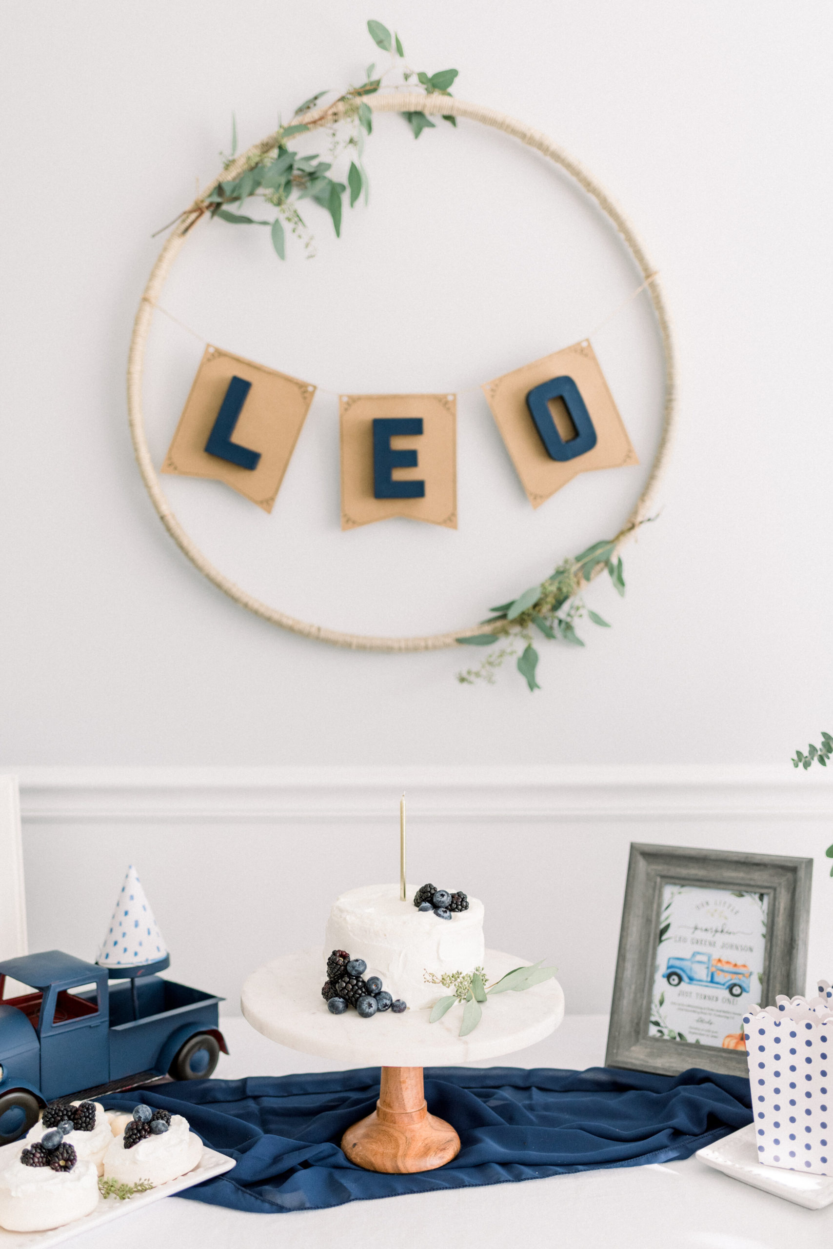 This LEO banner was fun! We used twine/jute string and hot glue to cover a hoola hoop and tied on some fresh eucalyptus. For the banner, we used this natural DIY banner from Party City and painted some cardboard letters from Hobby Lobby and stuck them on! I love how it turned out.